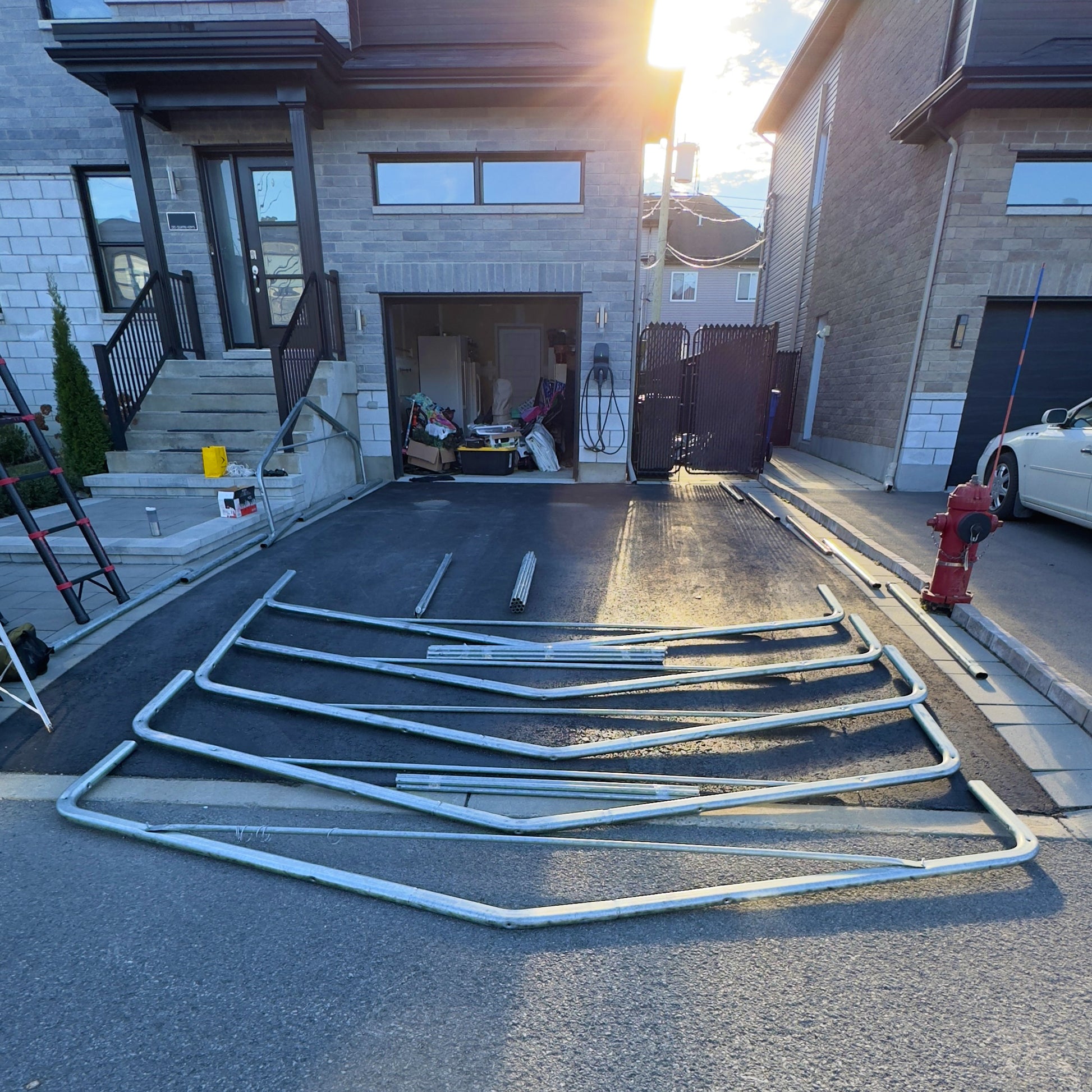 Metal Carport racks on a driveway in front of a house